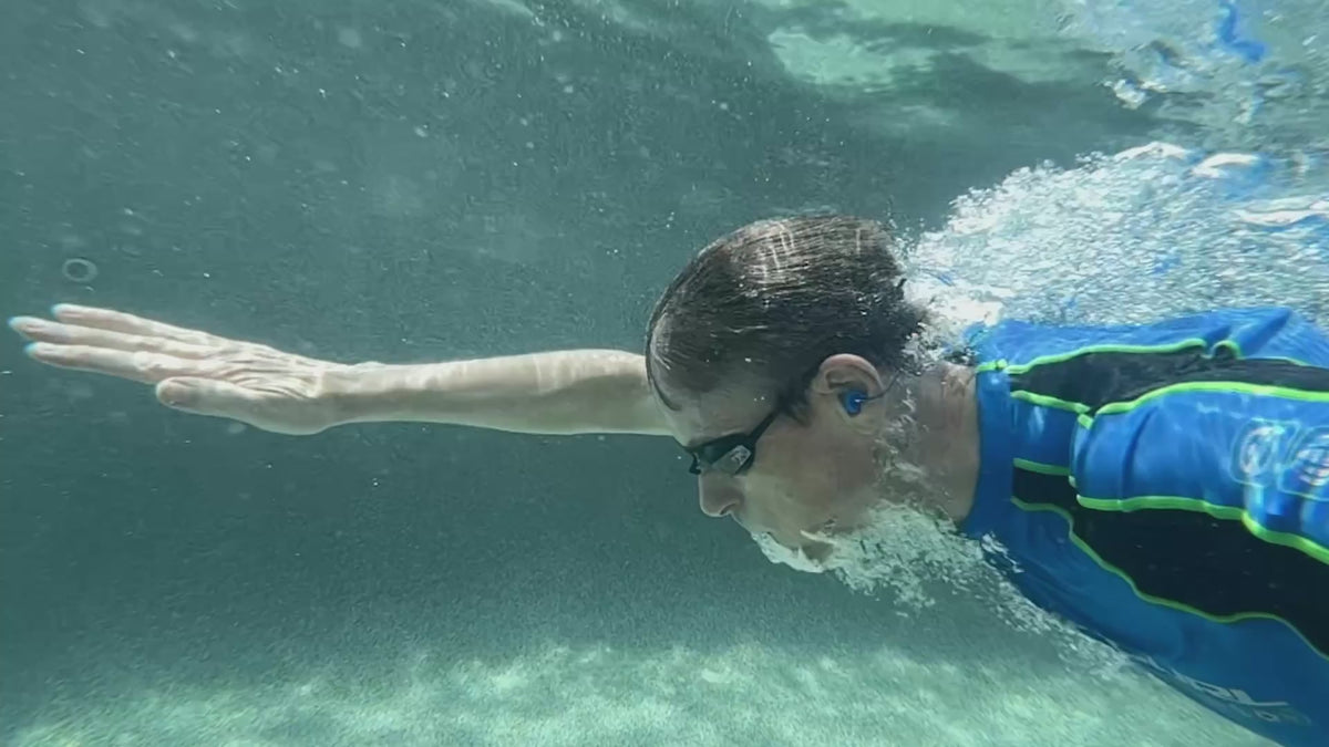 Load video: Swimmer underwater wearing Fluid earplugs